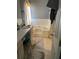 Bathroom featuring a vanity with sink and a built-in bathtub with white tiling at 232 Rockingham Dr, Loganville, GA 30052