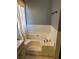 Spacious bathtub with tile surround and chrome faucet at 232 Rockingham Dr, Loganville, GA 30052