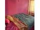 Vibrant bedroom with pink walls and layered bedding at 232 Rockingham Dr, Loganville, GA 30052