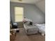 Bedroom with a window, chaise lounge, and twin bed, providing a comfortable space at 232 Rockingham Dr, Loganville, GA 30052
