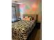 Bedroom with colorful accent wall and patterned bed at 232 Rockingham Dr, Loganville, GA 30052