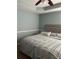 Cozy bedroom with light blue walls, a queen-sized bed, and a ceiling fan at 232 Rockingham Dr, Loganville, GA 30052