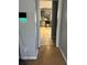 Hallway view into a well-lit kitchen featuring gray cabinets and tile flooring at 232 Rockingham Dr, Loganville, GA 30052