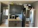 Kitchen area with a stainless steel refrigerator, dark gray cabinets, and sleek countertop appliances at 232 Rockingham Dr, Loganville, GA 30052