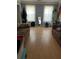 Spacious living room with hardwood floors, two windows, and neutral wall paint at 232 Rockingham Dr, Loganville, GA 30052