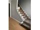 Staircase with carpeted steps and white railings leading to the second floor of the home at 232 Rockingham Dr, Loganville, GA 30052
