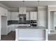 Modern kitchen featuring an island, white cabinets, granite counters, and stainless steel appliances at 491 Fescue Nw Ct, Kennesaw, GA 30144