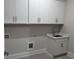Clean laundry room featuring white cabinets and countertop with sink at 491 Fescue Nw Ct, Kennesaw, GA 30144