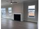 Bright living room with a fireplace, ceiling fan, and large windows at 491 Fescue Nw Ct, Kennesaw, GA 30144