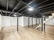 Large unfinished basement with painted joists, support beams, and updated flooring at 2308 Mark Trl, Decatur, GA 30032