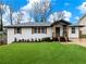 Charming home featuring a brick facade, covered entry, and well-manicured lawn at 2308 Mark Trl, Decatur, GA 30032