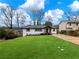 Charming home with a well-manicured lawn, complemented by an inviting entrance and driveway at 2308 Mark Trl, Decatur, GA 30032