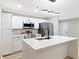 Modern kitchen featuring quartz countertops, island with black faucet, and stainless steel appliances at 2308 Mark Trl, Decatur, GA 30032