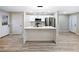 Modern kitchen featuring quartz countertops, island with black faucet, and stainless steel appliances at 2308 Mark Trl, Decatur, GA 30032