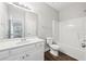 Bright bathroom features a white vanity with a large mirror and a shower and bathtub combination at 4416 Water Mill Dr, Buford, GA 30519