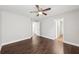 Light gray bedroom with dark wood floors and a ceiling fan at 4416 Water Mill Dr, Buford, GA 30519
