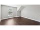 A bright bedroom features wood flooring, neutral walls, window, and white trim at 4416 Water Mill Dr, Buford, GA 30519
