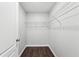Walk-in closet with shelving and dark wood floors at 4416 Water Mill Dr, Buford, GA 30519