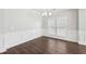 Formal dining room showcasing decorative wainscoting, wood-look floors, and large windows at 4416 Water Mill Dr, Buford, GA 30519