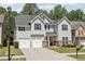Beautiful two-story home with gray siding, black shutters, and a well-maintained front yard at 4416 Water Mill Dr, Buford, GA 30519