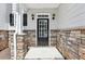Welcoming front entrance with stone accents, a multi-paneled door, and outdoor sconces at 4416 Water Mill Dr, Buford, GA 30519
