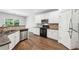 Modern kitchen featuring white cabinets, stainless steel appliances, and granite countertops at 4416 Water Mill Dr, Buford, GA 30519