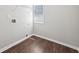 A small laundry room showcases wood flooring, neutral walls, and a window at 4416 Water Mill Dr, Buford, GA 30519