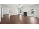 Bright living room featuring a fireplace, hardwood floors, and access to the backyard at 4416 Water Mill Dr, Buford, GA 30519