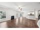 Open-concept living area with a fireplace, wood floors, and natural light at 4416 Water Mill Dr, Buford, GA 30519