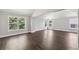 Spacious living room featuring many windows, light gray walls, and dark wood floors at 4416 Water Mill Dr, Buford, GA 30519