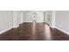 A spacious living room is shown with light gray walls and dark wood floors at 4416 Water Mill Dr, Buford, GA 30519