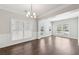 Large living room is filled with lots of light, with hardwood floors and crown molding at 4416 Water Mill Dr, Buford, GA 30519