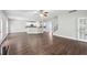 Spacious living room with hardwood floors, ceiling fan and a view of the kitchen at 4416 Water Mill Dr, Buford, GA 30519