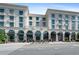 Elegant commercial building featuring a cream facade, black awnings, and well-manicured greenery along the street at 511 Burton Dr # 805, Alpharetta, GA 30009