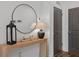 Entryway with natural wood table, dark accents and modern lighting at 511 Burton Dr # 805, Alpharetta, GA 30009