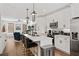 An open-concept kitchen with quartz countertops, pendant lighting, and stainless steel appliances at 511 Burton Dr # 805, Alpharetta, GA 30009