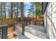 Backyard deck with gray metal railing sits aside a home with a wooden fence and mature trees at 578 Center Hill Nw Ave, Atlanta, GA 30318