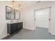 Sleek bathroom featuring a black vanity, double sinks, marble countertop, and sliding barn door at 578 Center Hill Nw Ave, Atlanta, GA 30318