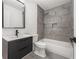 Modern bathroom features gray tiling in shower and floors, rainfall shower head, and black vanity at 578 Center Hill Nw Ave, Atlanta, GA 30318