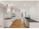 Modern kitchen with white cabinets, black countertops, and subway tile backsplash at 578 Center Hill Nw Ave, Atlanta, GA 30318