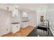 Modern kitchen with white cabinets, black countertops, and wood floors at 578 Center Hill Nw Ave, Atlanta, GA 30318