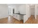 Spacious kitchen with white cabinets, black countertops, and wood flooring at 578 Center Hill Nw Ave, Atlanta, GA 30318
