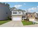 View of home with lawn and driveway with gray siding and brick two car garage at 103 Bryon Ln, Acworth, GA 30102
