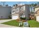 View of home with lawn and driveway with gray siding and brick two car garage at 103 Bryon Ln, Acworth, GA 30102