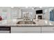 Kitchen island features a stainless steel sink and faucet with an open view of the living room at 103 Bryon Ln, Acworth, GA 30102