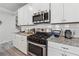 This kitchen features stainless steel appliances, granite countertops, and ample cabinet space at 103 Bryon Ln, Acworth, GA 30102