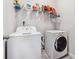 Bright laundry room with a white washer and dryer, and practical shelving for supplies at 103 Bryon Ln, Acworth, GA 30102