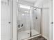 Modern shower features glass doors, tile surround, rainfall showerhead, and built-in bench at 103 Bryon Ln, Acworth, GA 30102