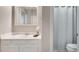 Bathroom with a single sink vanity, large mirror, and a shower with a curtain at 2000 Variations Dr, Atlanta, GA 30329