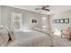 Well-lit bedroom featuring neutral walls and artwork. A comfortable chair complements the inviting space at 2000 Variations Dr, Atlanta, GA 30329
